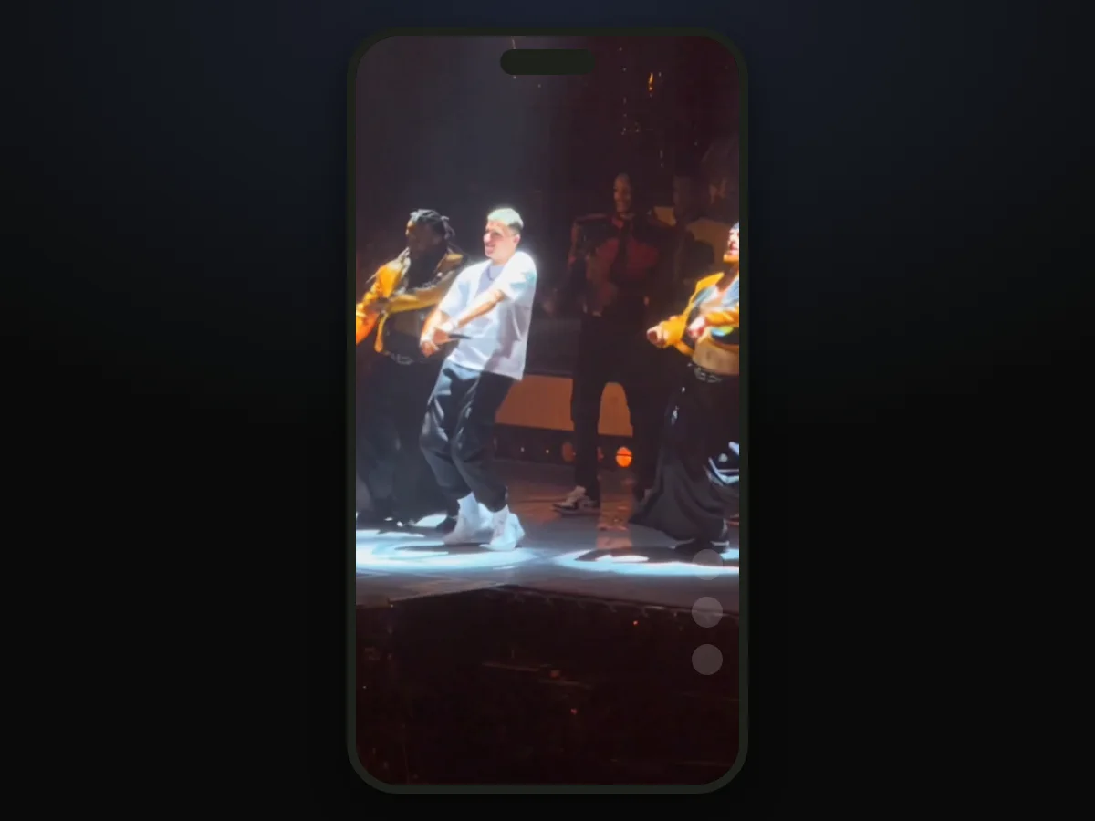 A finished Talk Dirty dance AI video on a phone screen in vertical 9:16, with the young man in the white T-shirt dancing in front of the varsity-jacket dancers