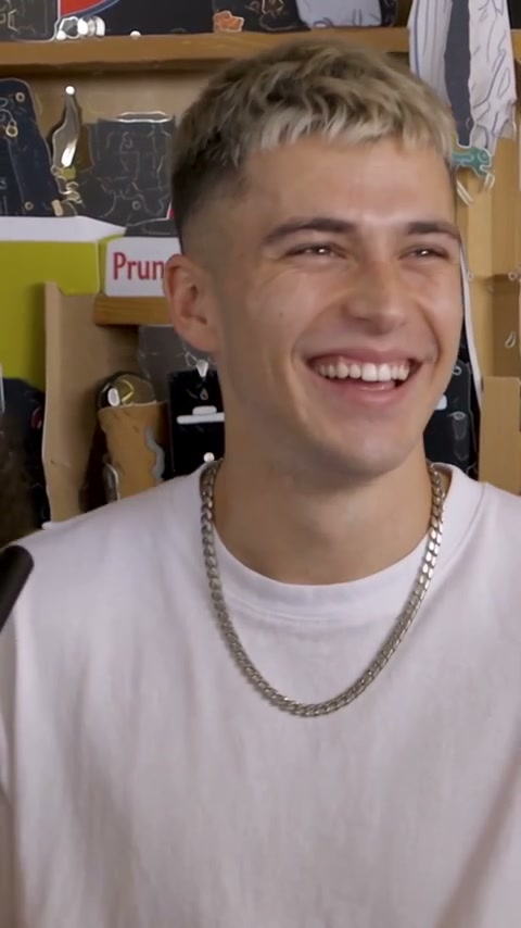 The lead singer's laughing close-up at 10.5 seconds of a Tiny Desk AI video